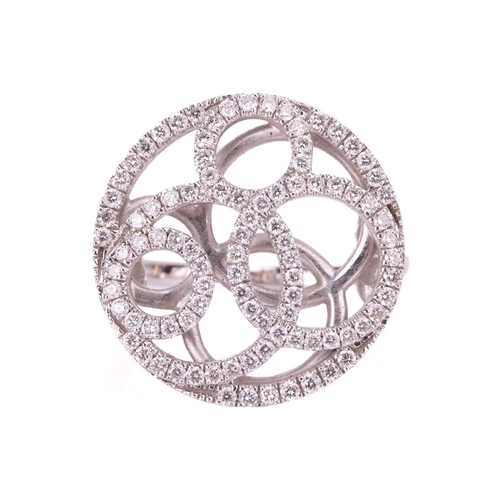 39 - A De Beers pierced panel ring in 18ct white gold, round head of swirl design encrusted with brillian... 