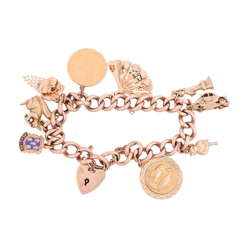 44 - A 9ct gold charm bracelet featuring nine charms including Lady Liberty, a Morris Minor car, a retrac... 