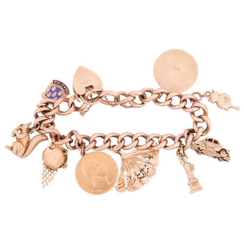 44 - A 9ct gold charm bracelet featuring nine charms including Lady Liberty, a Morris Minor car, a retrac... 