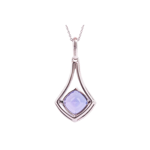 51 - A tanzanite and diamond-set drop pendant, featuring a cushion-cut tanzanite measuring approximately ... 