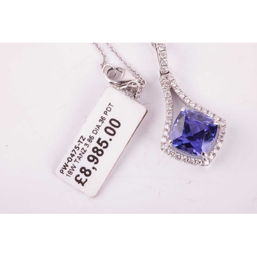 51 - A tanzanite and diamond-set drop pendant, featuring a cushion-cut tanzanite measuring approximately ... 