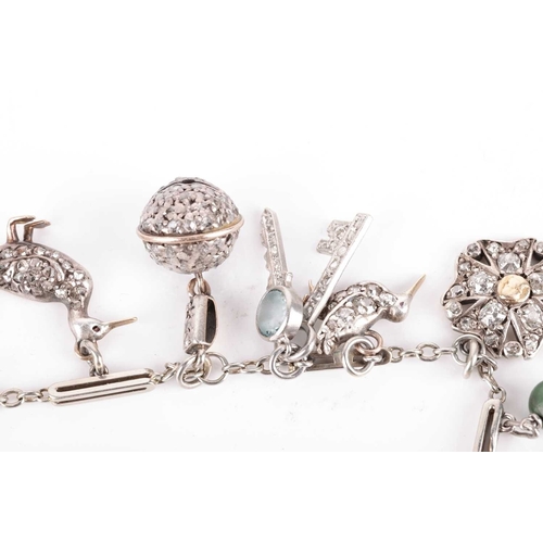 52 - An Art Deco gem-set charm bracelet, two signed Cartier; composed of a series of cable and bar links,... 