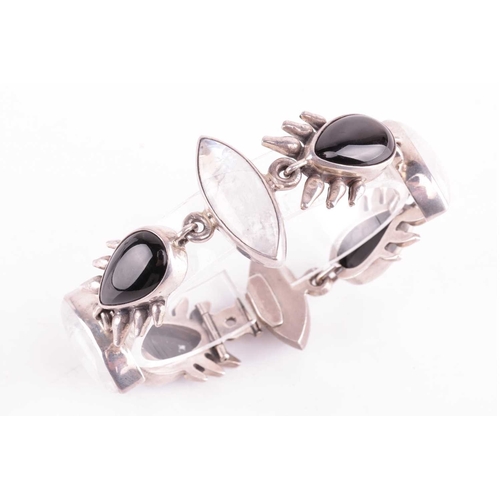 57 - A Whitby jet and labradorite link bracelet in silver, comprising four pear-shaped jets flanking thre... 