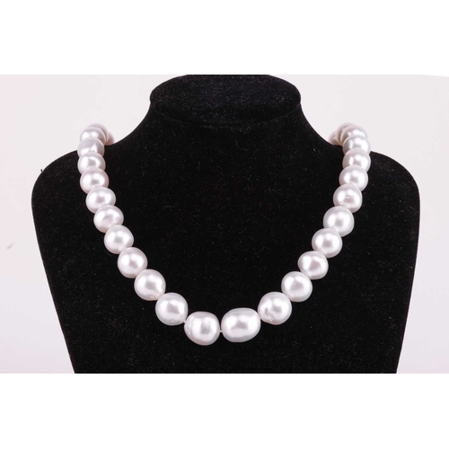 59 - Mikimoto - a single-strand South Sea pearl with a diamond-set clasp, comprising a row of graduated p... 