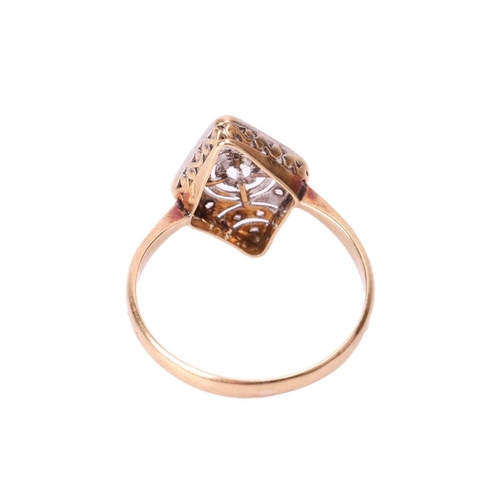 67 - A diamond-set plaque ring of rhombus shape, the pierced panel with millgrain details centred with a ... 