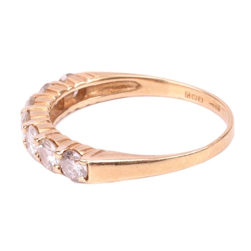 68 - A seven-stone diamond half-hoop ring in 18ct yellow gold, set with a row of slightly graduated brill... 