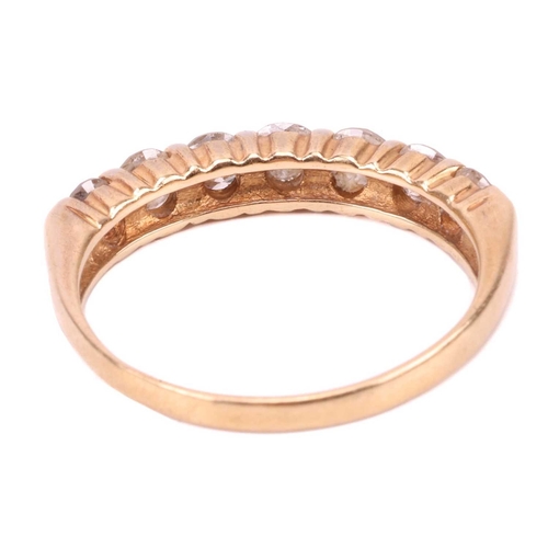 68 - A seven-stone diamond half-hoop ring in 18ct yellow gold, set with a row of slightly graduated brill... 