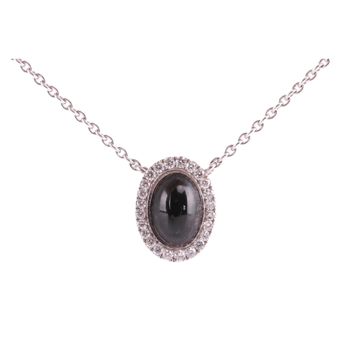 8 - A jet and diamond halo pendant, set in 18ct white gold, featuring an oval jet cabochon measuring app... 