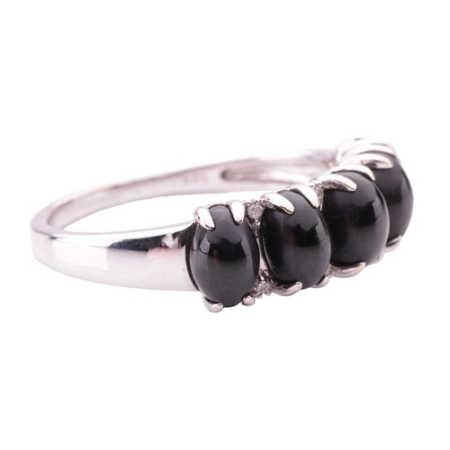 81 - A Whitby jet five-stone dress ring in 18ct white gold, claw-set with five oval jet cabochons, inters... 