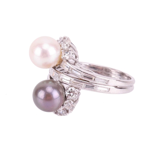 83 - A cultured pearl and diamond cross-over ring, featuring a white cultured pearl with silver overtones... 