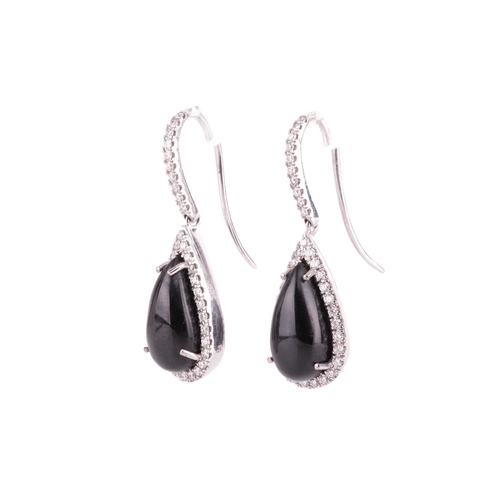 88 - A pair of Whitby jet and diamond drop earrings in 18ct white gold, each containing a teardrop-shaped... 