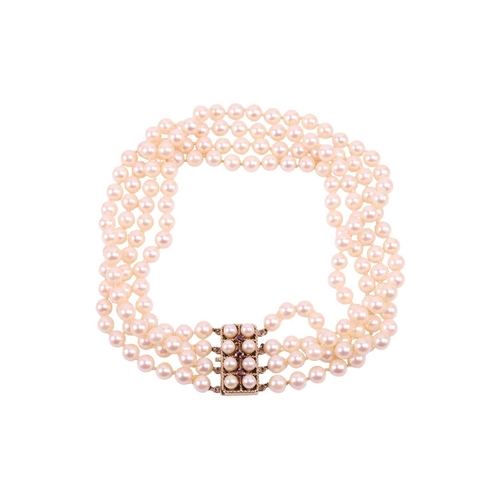 9 - A four-strand pearl choker necklace, the cultured pearls of cream body colour with pink overtones, m... 