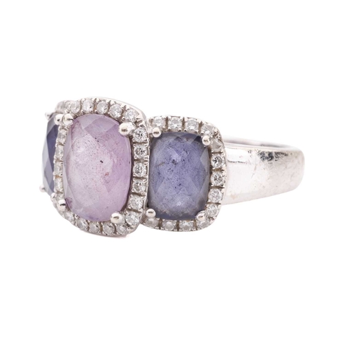 90 - An amethyst and diamond halo dress ring in 18ct white gold, featuring three graduated chequerboard-c... 