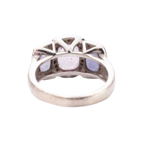 90 - An amethyst and diamond halo dress ring in 18ct white gold, featuring three graduated chequerboard-c... 