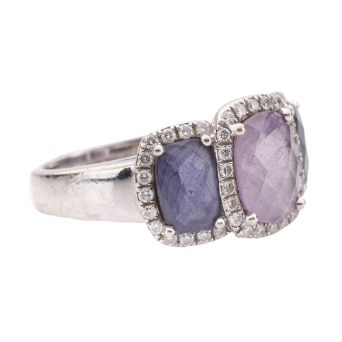 90 - An amethyst and diamond halo dress ring in 18ct white gold, featuring three graduated chequerboard-c... 