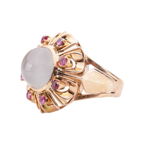 92 - A moonstone and ruby dress ring, centred with a round moonstone cabochon of 10.7 mm, in a surround e... 