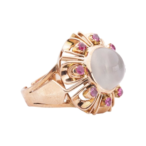 92 - A moonstone and ruby dress ring, centred with a round moonstone cabochon of 10.7 mm, in a surround e... 