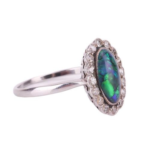 93 - An opal doublet and diamond cluster dress ring, the oval cabochon of 10.5 x 6.0 mm, displays strong ... 