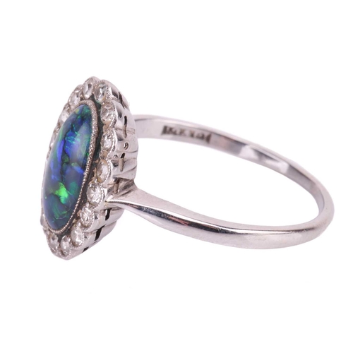 93 - An opal doublet and diamond cluster dress ring, the oval cabochon of 10.5 x 6.0 mm, displays strong ... 