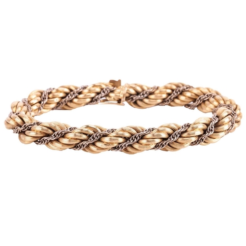 98 - A twisted rope bracelet in 18ct bi-coloured gold, of textured design, completed with a concealed pus... 