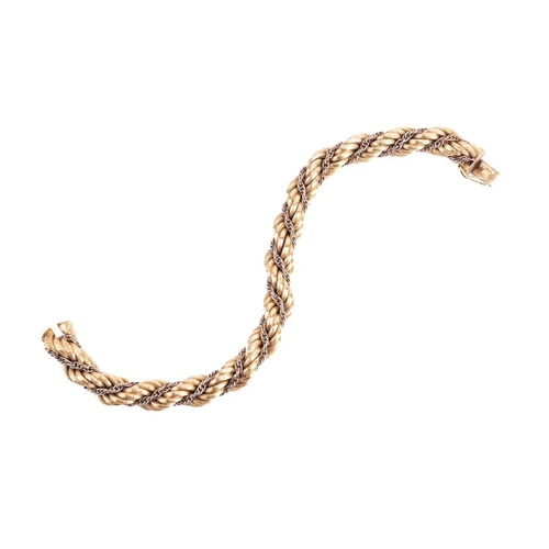 98 - A twisted rope bracelet in 18ct bi-coloured gold, of textured design, completed with a concealed pus... 