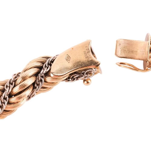 98 - A twisted rope bracelet in 18ct bi-coloured gold, of textured design, completed with a concealed pus... 