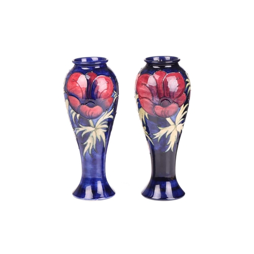 59 - A near pair of Walter Moorcroft tall vases, in the Anenome pattern, tube-lined decoration on a dark ... 