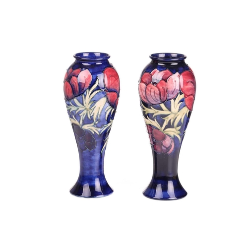 59 - A near pair of Walter Moorcroft tall vases, in the Anenome pattern, tube-lined decoration on a dark ... 