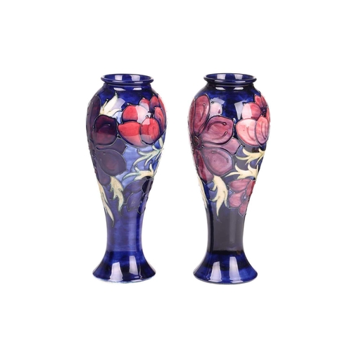 59 - A near pair of Walter Moorcroft tall vases, in the Anenome pattern, tube-lined decoration on a dark ... 