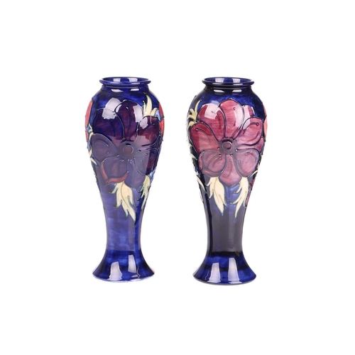 59 - A near pair of Walter Moorcroft tall vases, in the Anenome pattern, tube-lined decoration on a dark ... 