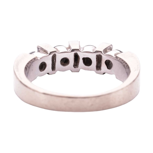 125 - A seven-stone diamond half hoop ring, the alternating baguette-cut white diamonds and treated round ... 