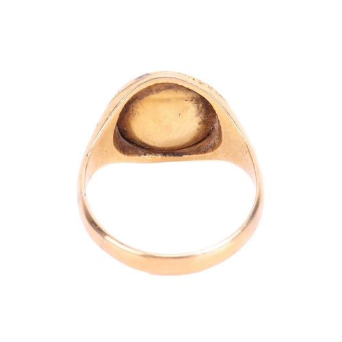 135 - A Victorian garnet and diamond halo ring in 18ct yellow gold, centred with a round garnet cabochon e... 