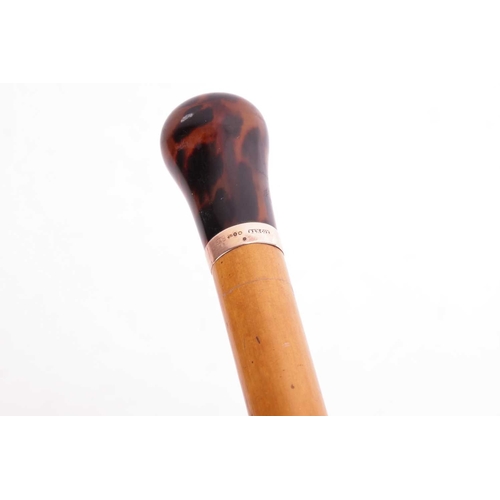 183 - A Malacca walking cane with resin pommel, the connecting gold band with hallmarks for 12ct gold and ... 