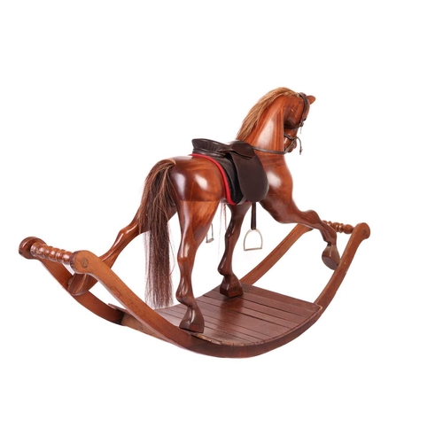 217 - A large polished mahogany rocking horse, 20th century with leather tack and horsehair tail and main,... 