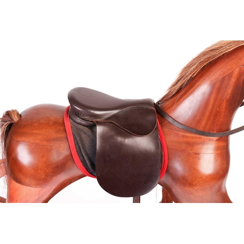 217 - A large polished mahogany rocking horse, 20th century with leather tack and horsehair tail and main,... 