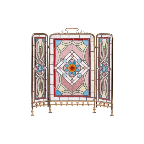 221 - A Victorian, Arts and Crafts style stained glass triptych fire screen, with gilt brass tubular outli... 