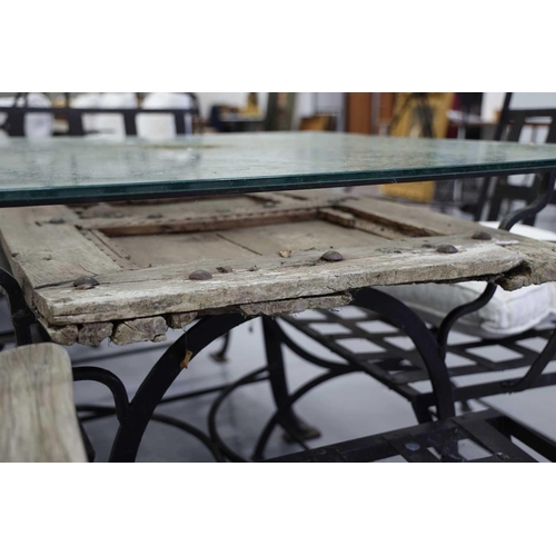 223 - A square blacksmith-made, black wrought iron garden table, 20th century, with heavy plate glass top ... 