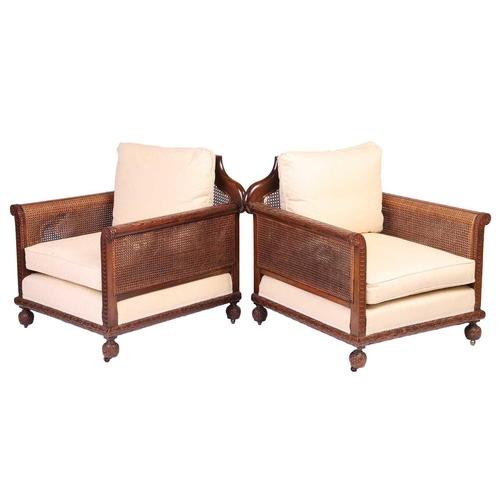 228 - A pair of Edwardian mahogany Bergere club armchairs, probably by Jas Shoolbred of London (unmarked),... 