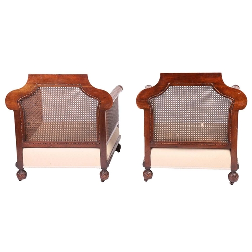 228 - A pair of Edwardian mahogany Bergere club armchairs, probably by Jas Shoolbred of London (unmarked),... 