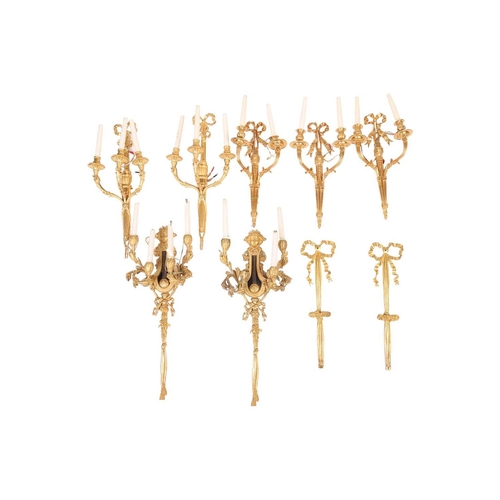 240 - A pair of Louis XVI ormolu four sconce wall lights, cast in the form of fruiting laurel branches and... 