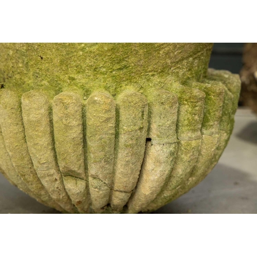 247 - A carved and established limestone campana urn constructed in sections, with a heavy gadrooned colla... 