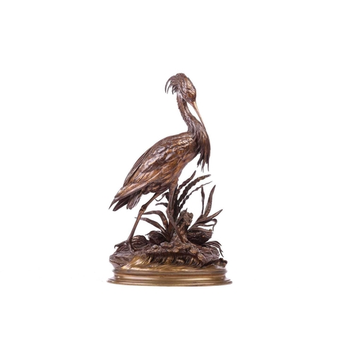 250 - Jules Moigniez (French 1835-1894), a patinated bronze model of a heron standing on a naturalistic ba... 