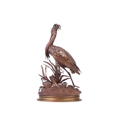 250 - Jules Moigniez (French 1835-1894), a patinated bronze model of a heron standing on a naturalistic ba... 