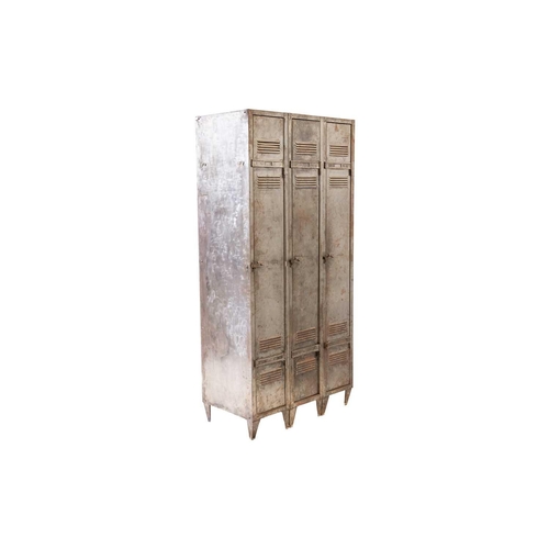 268 - A vintage industrial brushed steel three-door gym locker, with vented doors and squat angular feet. ... 