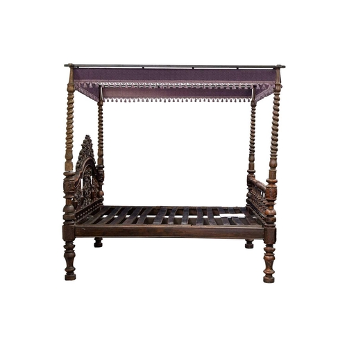 109 - A massive probably Ceylonese Four Poster Bed retailed by Liberty of London, with carved and pierced ... 