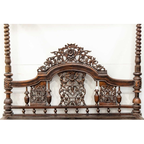 109 - A massive probably Ceylonese Four Poster Bed retailed by Liberty of London, with carved and pierced ... 