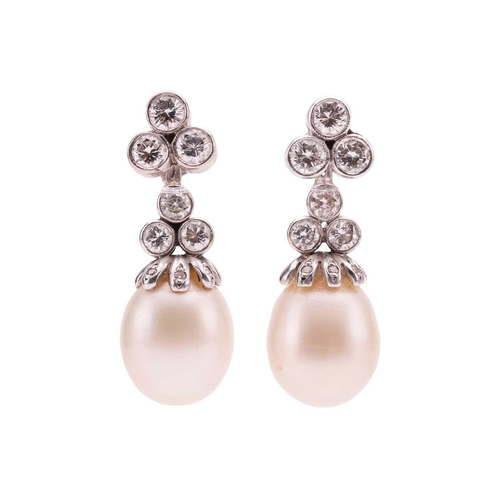 1 - A pair of diamond and pearl day and night earrings, surmounts of trefoil form suspending detachable ... 