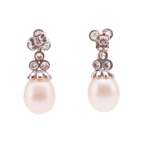 1 - A pair of diamond and pearl day and night earrings, surmounts of trefoil form suspending detachable ... 