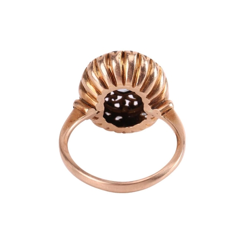 106 - A dress ring set with synthetic spinel, centred with an oval-cut synthetic spinel, claw-set to a pie... 