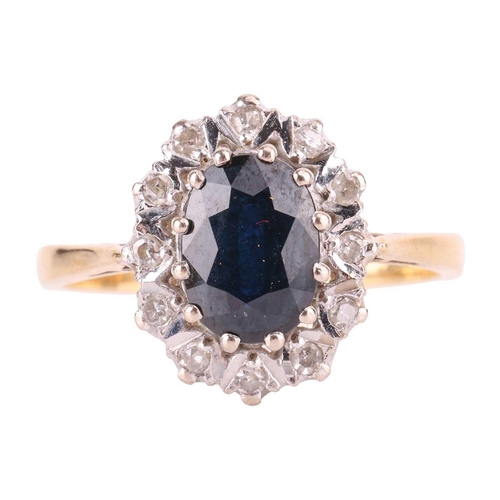 122 - A sapphire and diamond cluster ring in 18ct gold, comprising an oval-cut sapphire of dark blue colou... 